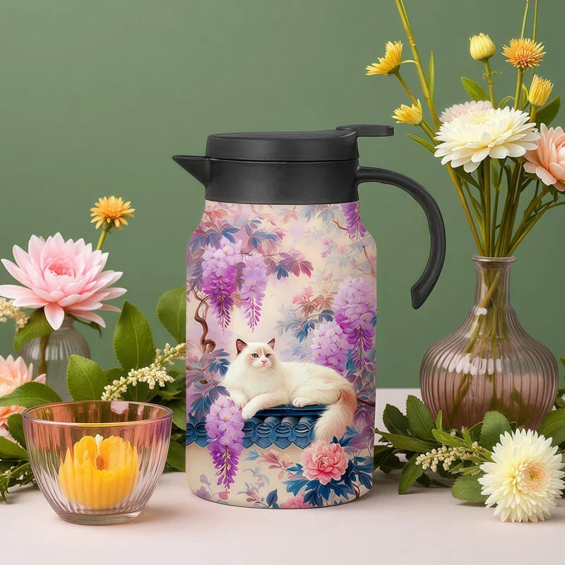 Vintage Floral Tea Thermos - Insulated carafe with wisteria and cat print, black lid and handle, displayed with fresh flowers and a small glass teacup