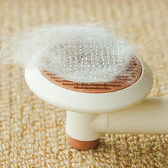 Dog Grooming Comb - Pet brush filled with white pet fur rests on a woven carpet surface
