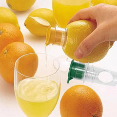 Hand squeezing orange into glass using citrus juicer, surrounded by lemons and oranges