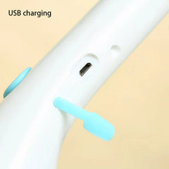 Scrubber Brush - Closeup of a white device with an exposed Micro USB charging port and attached light blue rubber port cover, text "USB charging" in corner