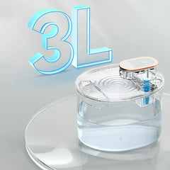 Transparent 3L pet water fountain with visible water level, pump module, on clear reflective surface showing water ripple effect