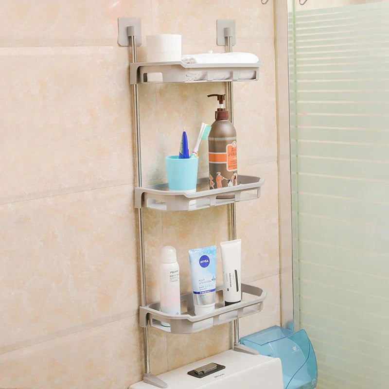 Storage Shelf Rack - 3-tier storage shelf mounted on a tiled bathroom wall, holding toiletries, with bottom feet resting on a toilet tank