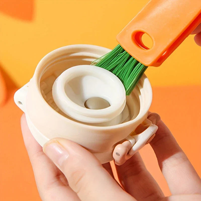Bottle Cap Cleaning Brush Tool - Carrot-shaped brush with green bristles scrubbing the inside of a white cup lid, held by two hands