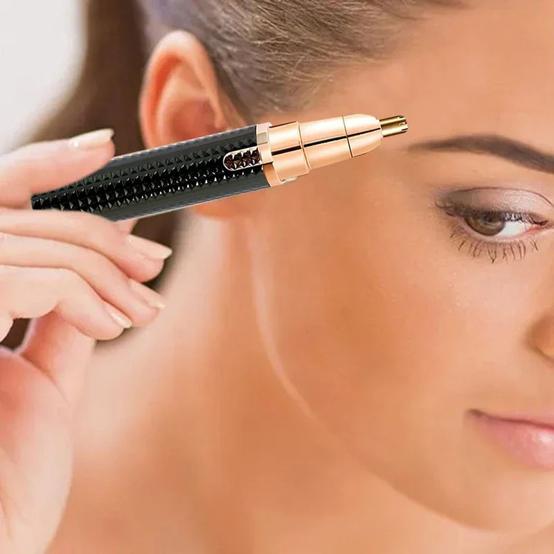 Hand holding a black and rose gold electric trimmer near a person’s eyebrow for facial hair grooming