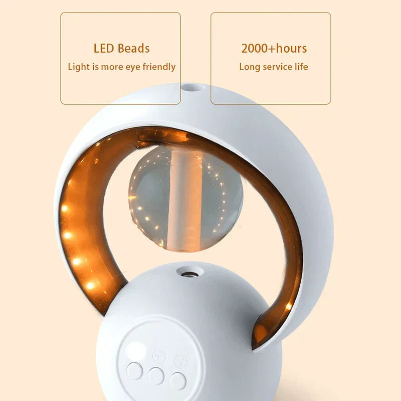 لقطة مقربة لمصباح ليلي مع مرطب هواء بحبيبات LED دافئة داخل إطار حلقي أبيض، تُظهر أزرار التحكم على قاعدته.