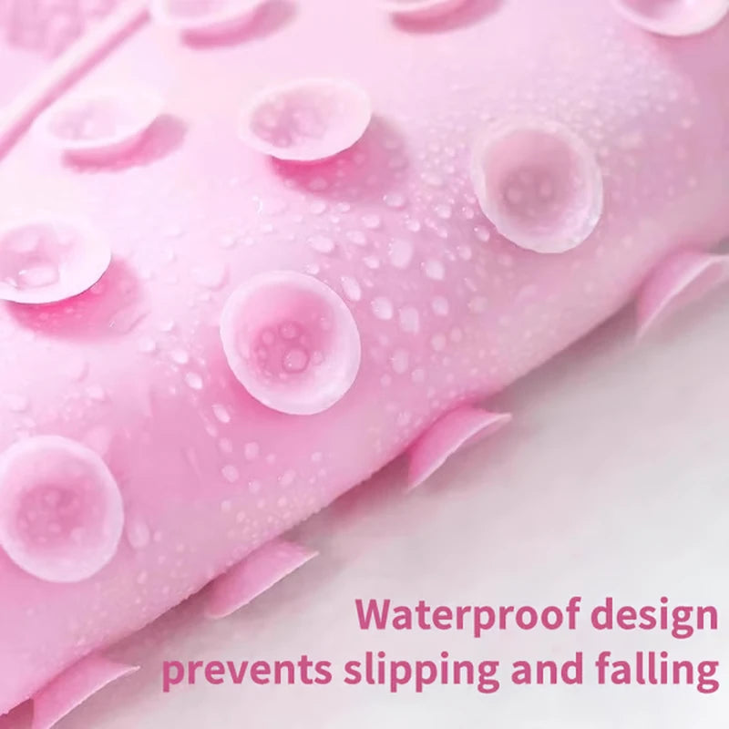 Close-up of the pink silicone shower foot scrubber mat's suction cup side with water droplets