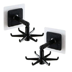 Adhesive Utensil Holder Hooks - Two black adhesive wall hooks with six-prong rotating ends and hinged arms, shown against a plain white background