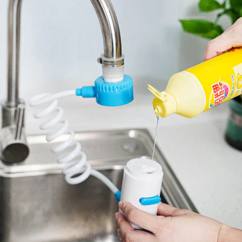 Swivel Faucet Extender - Faucet-mounted adapter with coiled hose, hand holding spray head near dish soap bottle