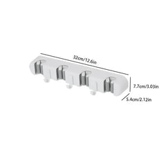 soporte de pared para trapeador y escoba - Organizador blanco de pared para trapeador y escoba con dimensiones etiquetadas de 32 cm, 7,7 cm y 5,4 cm, sobre fondo blanco
