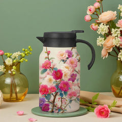 Vintage Floral Tea Thermos - Insulated carafe with pink and purple camellia floral print, black lid and handle, displayed with glass vases of flowers