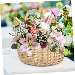 Storage Basket - Woven wicker basket holding a bouquet of pink lilies, a pink rose, baby's breath, and green foliage, placed on a white surface