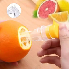 Hand inserting citrus juicer into cut orange, with inset showing prongs detail