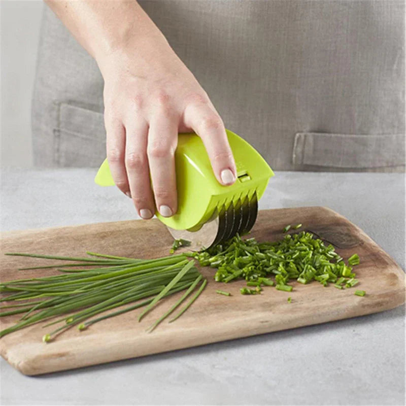 Pizza Dough Cutter Slicer - hand holding green 6-wheel slicer cutting chives on wooden cutting board