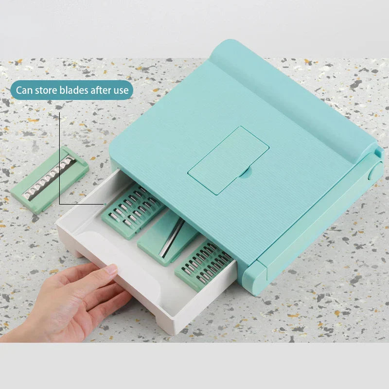 Vegetable Slicer Chopper - Mint green slicer with open white storage drawer holding spare blades, plus one loose blade beside it