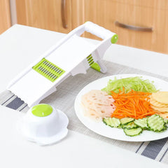 Vegetable Slicer Chopper - slicer set on kitchen counter next to plate of freshly cut carrot, cucumber, lotus root, and potato slices