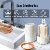 White soap grinding box shown open with bar soap inside, next to a closed unit on a bathroom sink counter, with feature icons above.