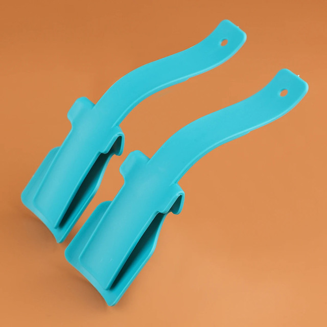 Shoe Helper - Two turquoise plastic curved clips resting on an orange surface