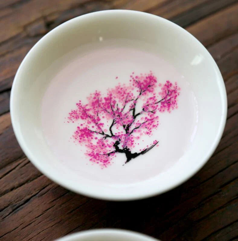 Sakura Sake Cup - White ceramic cup interior with fully visible soft magenta peach blossom tree design