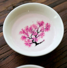 Sakura Sake Cup - White ceramic cup interior with fully visible soft magenta peach blossom tree design