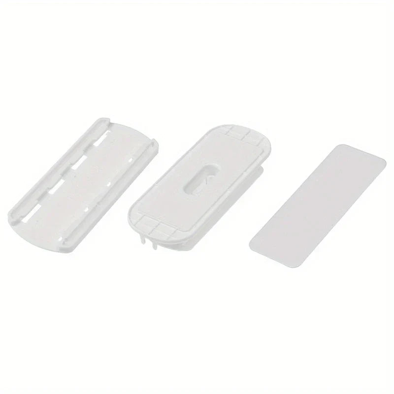 Power Strip Holder - Three-piece white plastic mounting set laid out on plain background