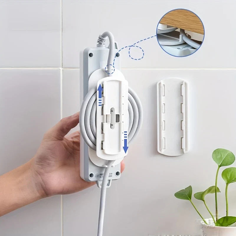 Power Strip Holder - Hand holding a white power strip attached to a wall-mounted white clip, with coiled cable and a separate wall clip shown