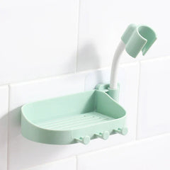 Shower Head Holder - Light green wall-mounted soap dish with hooks and a curved hose clip, attached to a white tiled wall.