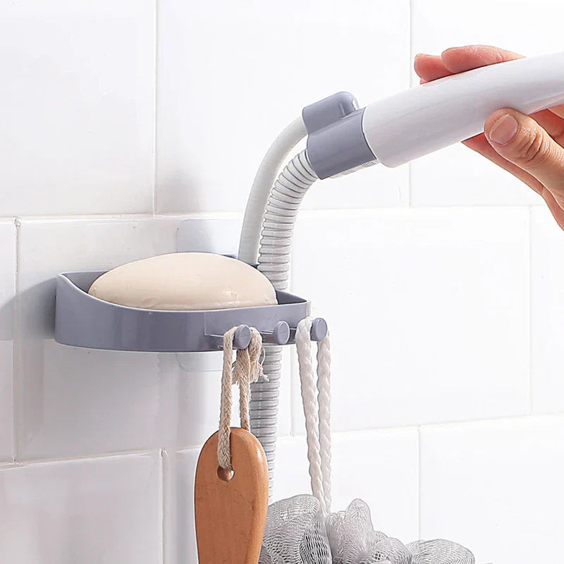 Shower Head Holder - Gray wall-mounted soap dish bracket with flexible mount holding a handheld shower wand