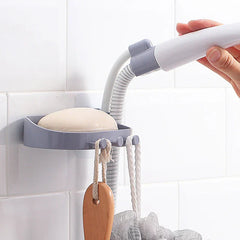 Shower Head Holder - Gray wall-mounted soap dish bracket with flexible mount holding a handheld shower wand