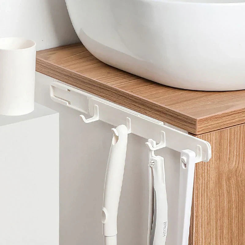 Wall Hook Hanger - White hook rack mounted under bathroom vanity shelf holding toothbrushes and tools