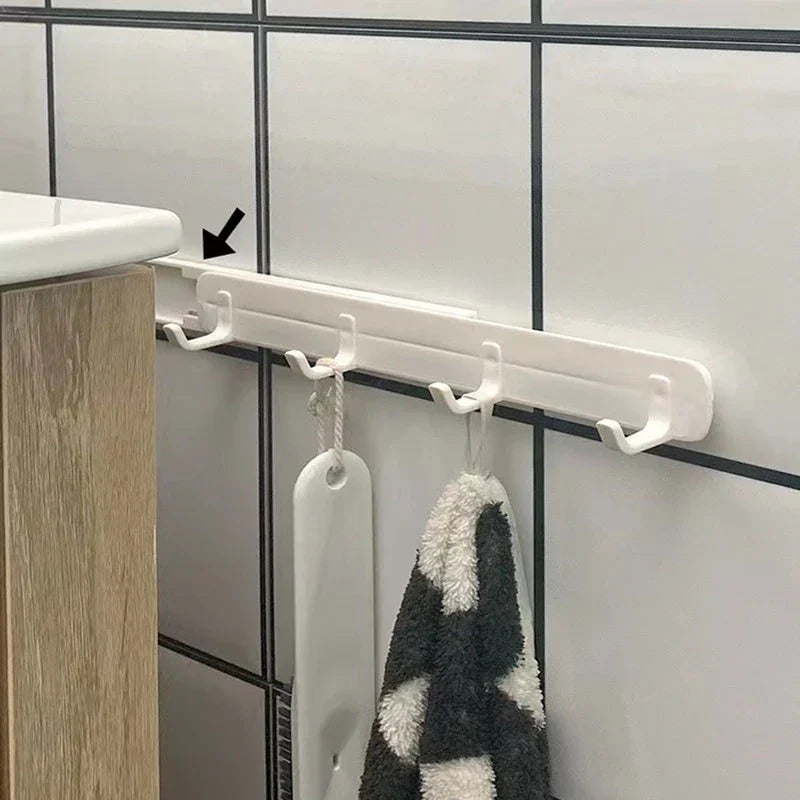 Wall Hook Hanger - White hook rack mounted on tiled bathroom wall holding towel and scrub brush