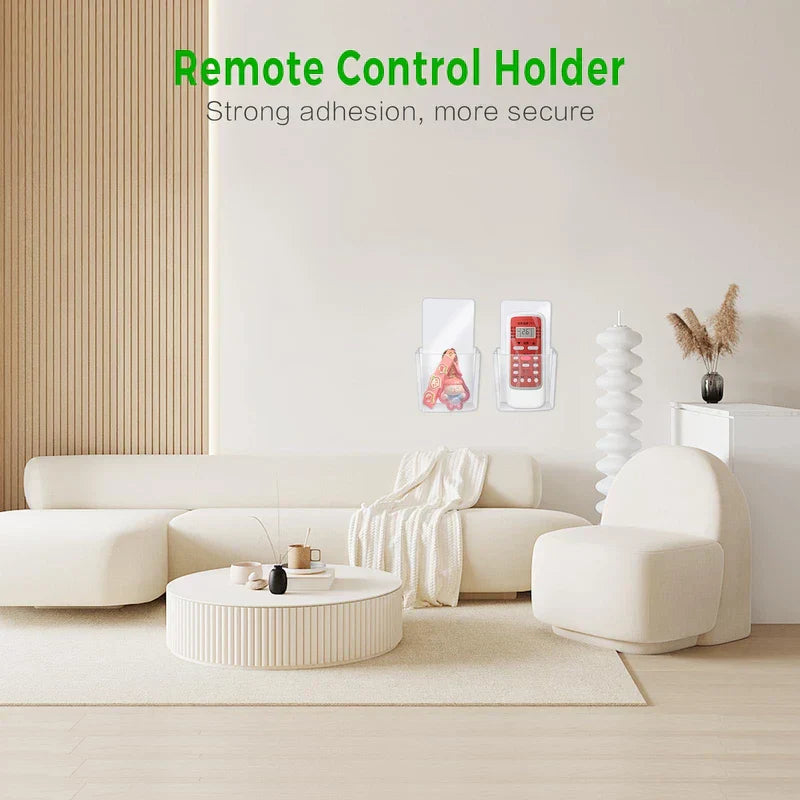 Storage Box - Living room scene with two clear wall-mounted holders on a white wall: one holds a small item, the other holds a red remote control.
