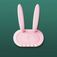 Utility Hooks - Pink rabbit-shaped organizer with long ears, dotted face, five bottom bumps, against dark green background.