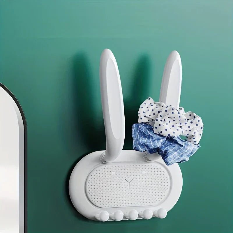 Utility Hooks - White bunny-shaped adhesive hook on teal wall holding fabric scrunchies