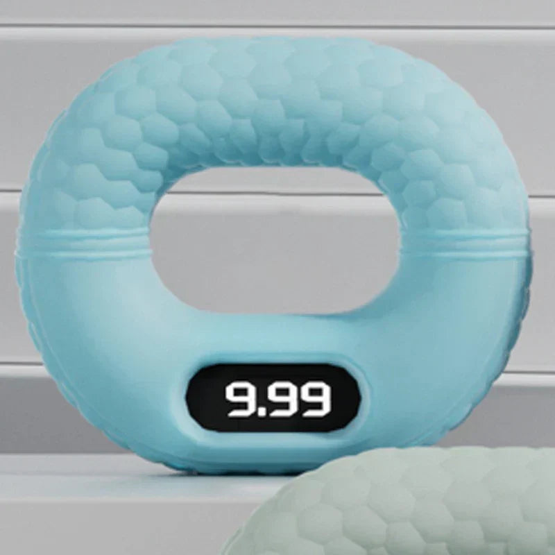 Light blue silicone hand grip strengthener with digital display showing 9.99, on gray shelf