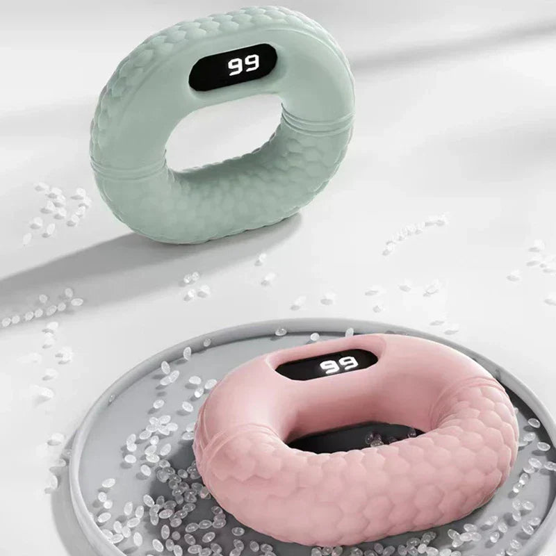 Hand Grip Strengthener - Light green and pink silicone hand grip strengtheners with digital displays showing 99, surrounded by clear beads