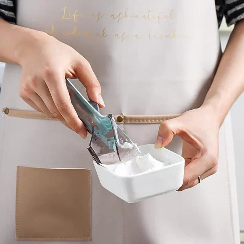 Adjustable Measuring Spoon - A person holds a white container of powder in one hand, using a translucent teal measuring scoop with a lever to release powder into the container.