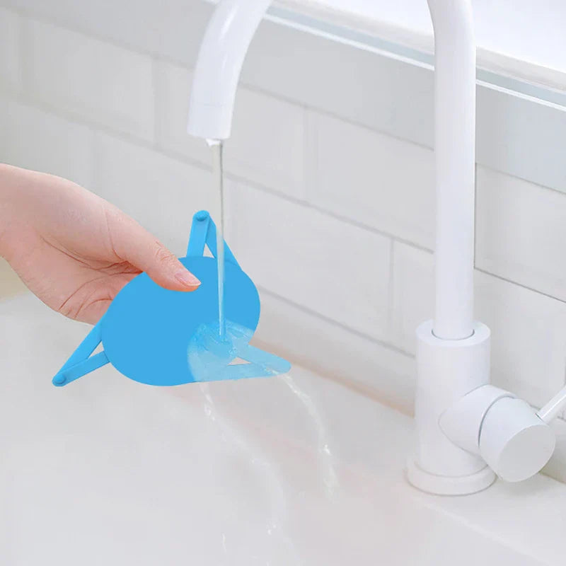 Shelf Organizer Rack - Hand holding a blue triangular device under a running bathroom sink faucet, water flowing through the device