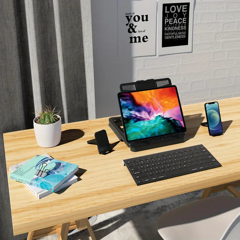Tablet Desk Mount Stand - Wooden desk with a tablet on a black stand, wireless keyboard, two phone stands, books, and a potted cactus