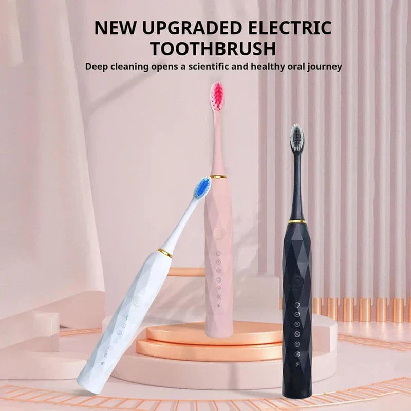 Toothbrush Kit - Three electric toothbrushes (white, pink, black) displayed on tiered rose gold platforms with pink drape background