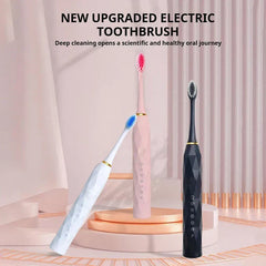 Toothbrush Kit - Three electric toothbrushes (white, pink, black) displayed on tiered rose gold platforms with pink drape background