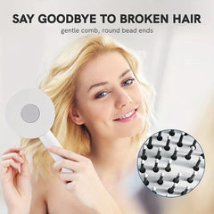cepillo desenredante para el cabello - persona sosteniendo el cepillo cerca del cabello rubio con primer plano de las puntas redondas de las cerdas