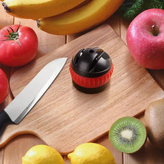Knife Sharpener System - Small sharpening tool placed on wooden cutting board surrounded by fresh fruits, vegetables, and a kitchen knife