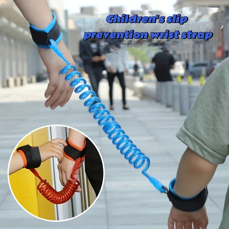 Wrist Link - Adult and child hands wearing connected blue coiled wrist straps, with an inset showing orange coiled wrist straps on adult and child wrists