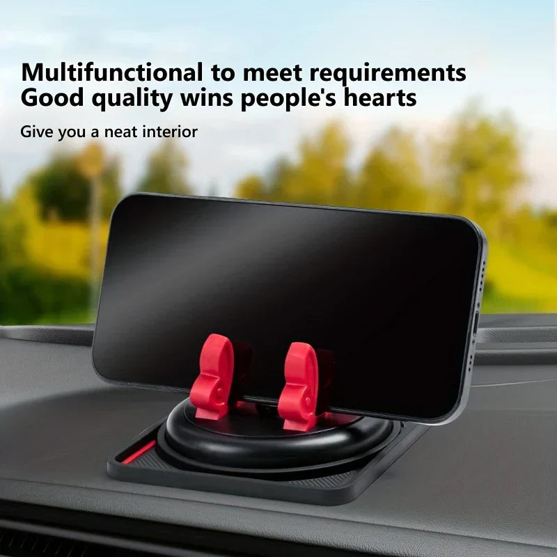 Dashboard Pad - Black smartphone held by red clips of a dashboard phone holder on a car dashboard, with outdoor background