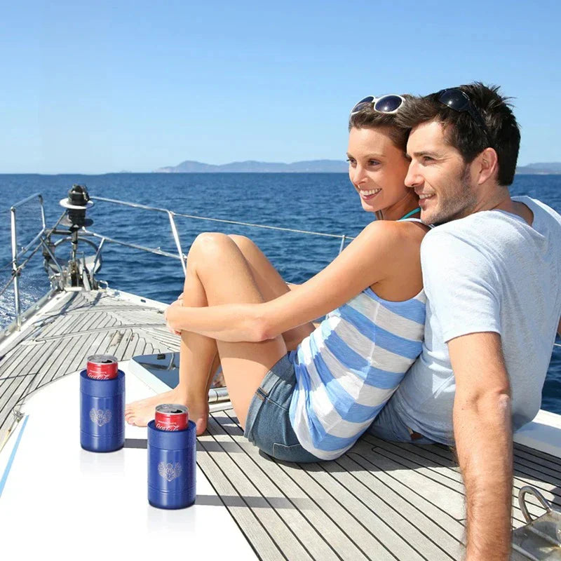 portavasos aislante para latas con base antideslizante - una pareja sentada en la cubierta de un velero con dos portavasos azules sosteniendo latas de refresco rojas, contemplando el océano
