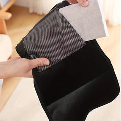 Compression Massager - Hands hold a black fabric wrap showing a mesh panel and light gray fabric insert