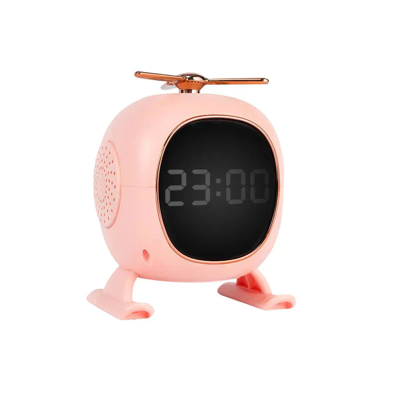 Pink helicopter-shaped digital alarm clock with rose gold accents stands against a white background