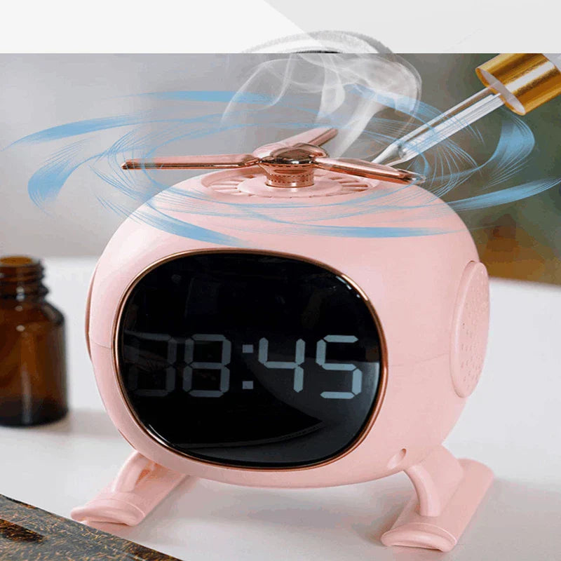 Pink helicopter-shaped digital clock emits mist from its top rotor, with an essential oil bottle beside it on a table