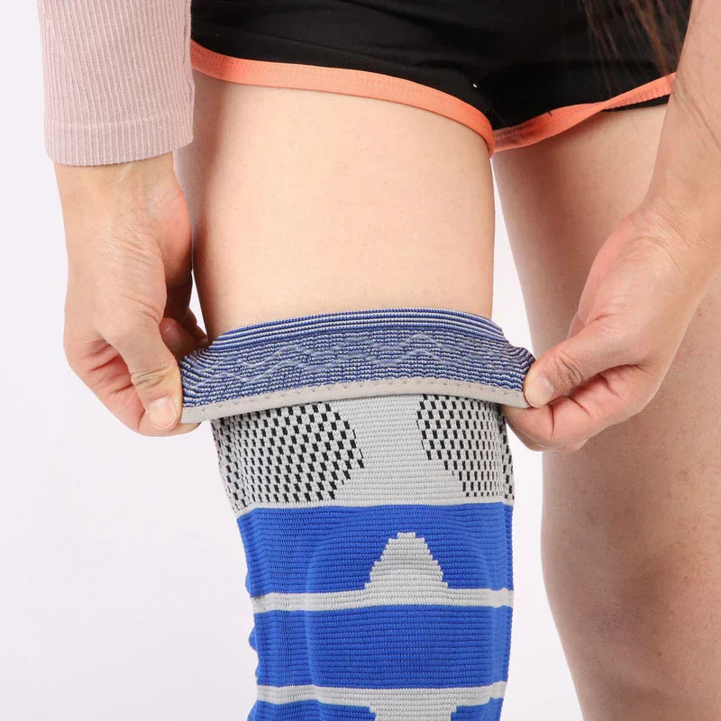 Knee Support Sleeve - Person pulling a blue and gray knit knee sleeve up their leg