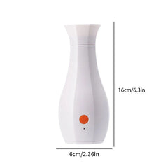 Máquina de perfume - Dispositivo blanco con forma de jarrón con botón de encendido naranja y etiquetas de tamaño 16 cm x 6 cm